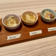 I tried the different gravy options atop mashed potatoes, in tiny bowls, where the variation in gravy color is evident.
